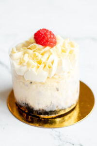 Mini cheesecake topped with frosting and raspberry as made famous by Sweets by Diane in Roseville, Minnesota.