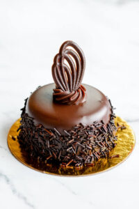 Mini chocolate cake topped with chocolate designs as made famous by Sweets by Diane in Roseville, Minnesota.