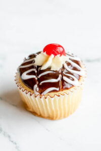 Vanilla cupcake topped with cherry as made famous by Sweets by Diane in Roseville, Minnesota