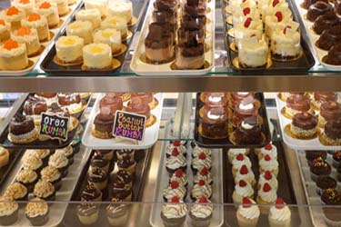 Assortment of many different cupcakes and treats served at Sweet & Savory By Diane in Roseville Minnesota at the POTLUCK Food Hall in Rosedale Center.